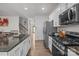 Modern kitchen featuring stainless steel appliances, granite countertops, and hardwood flooring at 413 Wheat Field Dr, Mount Holly, NC 28120