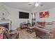Spacious living room with a fireplace, hardwood floors, ceiling fan, and ample seating at 413 Wheat Field Dr, Mount Holly, NC 28120