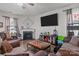 Cozy living room with a fireplace, ceiling fan, hardwood floors, and comfortable seating at 413 Wheat Field Dr, Mount Holly, NC 28120