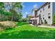 Spacious backyard featuring a patio, outdoor grill and mature trees at 4151 Green Park Ct, Harrisburg, NC 28075