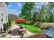 Private backyard with patio, dining set, lush lawn, and wooded backdrop at 4151 Green Park Ct, Harrisburg, NC 28075