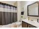 This bathroom features a black and gray shower curtain, large mirror, and vanity at 4151 Green Park Ct, Harrisburg, NC 28075
