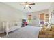 Large bedroom with carpet, a white crib, a couch, and natural light at 4151 Green Park Ct, Harrisburg, NC 28075