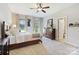 This bedroom has natural light, a ceiling fan, and an attached bathroom at 4151 Green Park Ct, Harrisburg, NC 28075