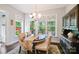 The dining area includes large windows, an oval table with seating for four, and an attractive china cabinet at 4151 Green Park Ct, Harrisburg, NC 28075