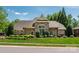 Well-maintained home with stone facade, landscaped front yard, and mature trees at 4151 Green Park Ct, Harrisburg, NC 28075