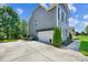 Home exterior featuring a driveway, manicured lawn, and attached garage at 4151 Green Park Ct, Harrisburg, NC 28075