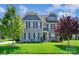 Beautiful two-story home with lush green lawn, attractive landscaping and trees at 4151 Green Park Ct, Harrisburg, NC 28075