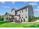 Two-story home with gray siding, well-manicured lawn, and patio area at 4151 Green Park Ct, Harrisburg, NC 28075