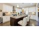 Bright kitchen features white cabinets, stainless steel appliances, granite counters, and island with barstool seating at 4151 Green Park Ct, Harrisburg, NC 28075