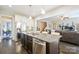 Spacious kitchen with island overlooking the living room and stainless steel appliances at 4151 Green Park Ct, Harrisburg, NC 28075