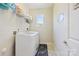 A dedicated laundry room that includes a washer, dryer, and storage shelving at 4151 Green Park Ct, Harrisburg, NC 28075