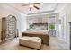 This main bedroom features carpeted floors, a ceiling fan, and a large bed at 4151 Green Park Ct, Harrisburg, NC 28075