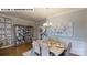 Elegant dining room with hardwood floors, modern chandelier, and large china cabinet at 505 York Rd, Troutman, NC 28166