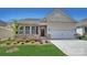 Charming single-story home features a two-car garage, brick accents, and well-manicured lawn under a clear blue sky at 505 York Rd, Troutman, NC 28166