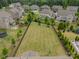Aerial view of the expansive backyard, showcasing a well-manicured lawn and black metal fence at 515 Lizzie Ln, Fort Mill, SC 29708