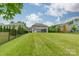 Spacious backyard featuring a large grassy area and secure black fence for outdoor enjoyment at 515 Lizzie Ln, Fort Mill, SC 29708