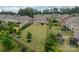 Large, fenced backyard featuring a lush lawn with mature trees and neighborhood views at 515 Lizzie Ln, Fort Mill, SC 29708