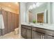 Bathroom with double sinks, grey cabinets and a shower behind a curtain at 515 Lizzie Ln, Fort Mill, SC 29708