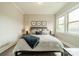 Comfortable bedroom featuring a plush bed with decorative pillows, bedside tables with lamps, and ample natural light at 515 Lizzie Ln, Fort Mill, SC 29708