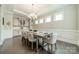 Elegant dining room with hardwood floors, built-in cabinets, stylish lighting, and seating for eight at 515 Lizzie Ln, Fort Mill, SC 29708