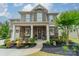 Beautiful two-story home showcasing a stone facade, landscaped garden, and a welcoming front porch at 515 Lizzie Ln, Fort Mill, SC 29708