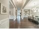 Spacious hallway leading to dining area with hardwood floors, white trim, and elegant chandelier at 515 Lizzie Ln, Fort Mill, SC 29708