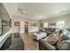Open-concept living room with hardwood floors, neutral paint, and comfortable gray leather sectional sofa at 515 Lizzie Ln, Fort Mill, SC 29708