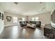 Spacious living room featuring hardwood floors, recessed lighting, and a large leather sectional sofa at 515 Lizzie Ln, Fort Mill, SC 29708