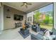 Comfortable screened porch with outdoor seating and a mounted television for entertainment at 515 Lizzie Ln, Fort Mill, SC 29708