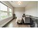 Sitting area with two chairs, ottoman with throw, and a view of the neighborhood through the windows at 515 Lizzie Ln, Fort Mill, SC 29708