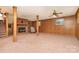 Basement with carpeted floors, paneled walls, and brick fireplace with a vintage ceiling fan at 52 September Ct, Concord, NC 28025