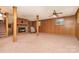 Basement with carpeted floors, paneled walls, and brick fireplace with vintage ceiling fan at 52 September Ct, Concord, NC 28025