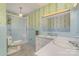 A bathroom featuring blue tile, patterned wallpaper, a walk-in shower, and white countertops at 52 September Ct, Concord, NC 28025