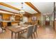 Open dining room and kitchen area featuring brick floors, wood beams and cabinets, and modern appliances at 52 September Ct, Concord, NC 28025