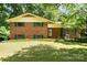 Charming front exterior of brick home with green shutters and well-manicured lawn at 52 September Ct, Concord, NC 28025