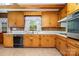 Bright kitchen with wood cabinetry, stainless steel oven, tiled backsplash, and brick-style flooring for cozy appeal at 52 September Ct, Concord, NC 28025
