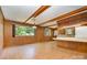 Open kitchen and dining area featuring wood paneling, brick-style flooring, and ample natural light at 52 September Ct, Concord, NC 28025