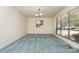 Bright living room with large windows providing natural light, textured blue carpet, and clean, white walls at 52 September Ct, Concord, NC 28025