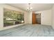 A bright living room with a large window overlooking the yard, patterned wallpaper, and green carpet at 52 September Ct, Concord, NC 28025