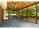 Spacious screened porch with wood lattice, perfect for outdoor relaxation and entertaining with wooded views at 52 September Ct, Concord, NC 28025