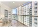 Spacious tiled balcony with glass railings and city views at 520 E Martin Luther King Jr Blvd # 1002, Charlotte, NC 28202