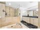Luxurious bathroom showcasing a soaking tub, a walk-in shower, and double sinks at 520 E Martin Luther King Jr Blvd # 1002, Charlotte, NC 28202