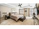 Spacious bedroom with tray ceiling, ceiling fan, neutral colors, bench, and large windows at 520 E Martin Luther King Jr Blvd # 1002, Charlotte, NC 28202