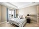 This is a bedroom with neutral tones and a private balcony with natural light at 520 E Martin Luther King Jr Blvd # 1002, Charlotte, NC 28202