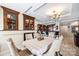 Dining area with dark wood cabinets, a fireplace, an elegant chandelier, and natural light at 520 E Martin Luther King Jr Blvd # 1002, Charlotte, NC 28202