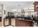 Modern kitchen with stainless steel appliances, granite countertops, and access to living and dining area at 520 E Martin Luther King Jr Blvd # 1002, Charlotte, NC 28202
