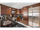 Modern kitchen with granite countertops, stainless steel appliances, and dark wood cabinets at 520 E Martin Luther King Jr Blvd # 1002, Charlotte, NC 28202