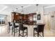 Modern kitchen featuring a breakfast bar, dark wood cabinets, and tile backsplash at 520 E Martin Luther King Jr Blvd # 1002, Charlotte, NC 28202