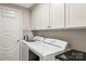 This is a functional laundry area with a washer, dryer and storage cabinets at 520 E Martin Luther King Jr Blvd # 1002, Charlotte, NC 28202